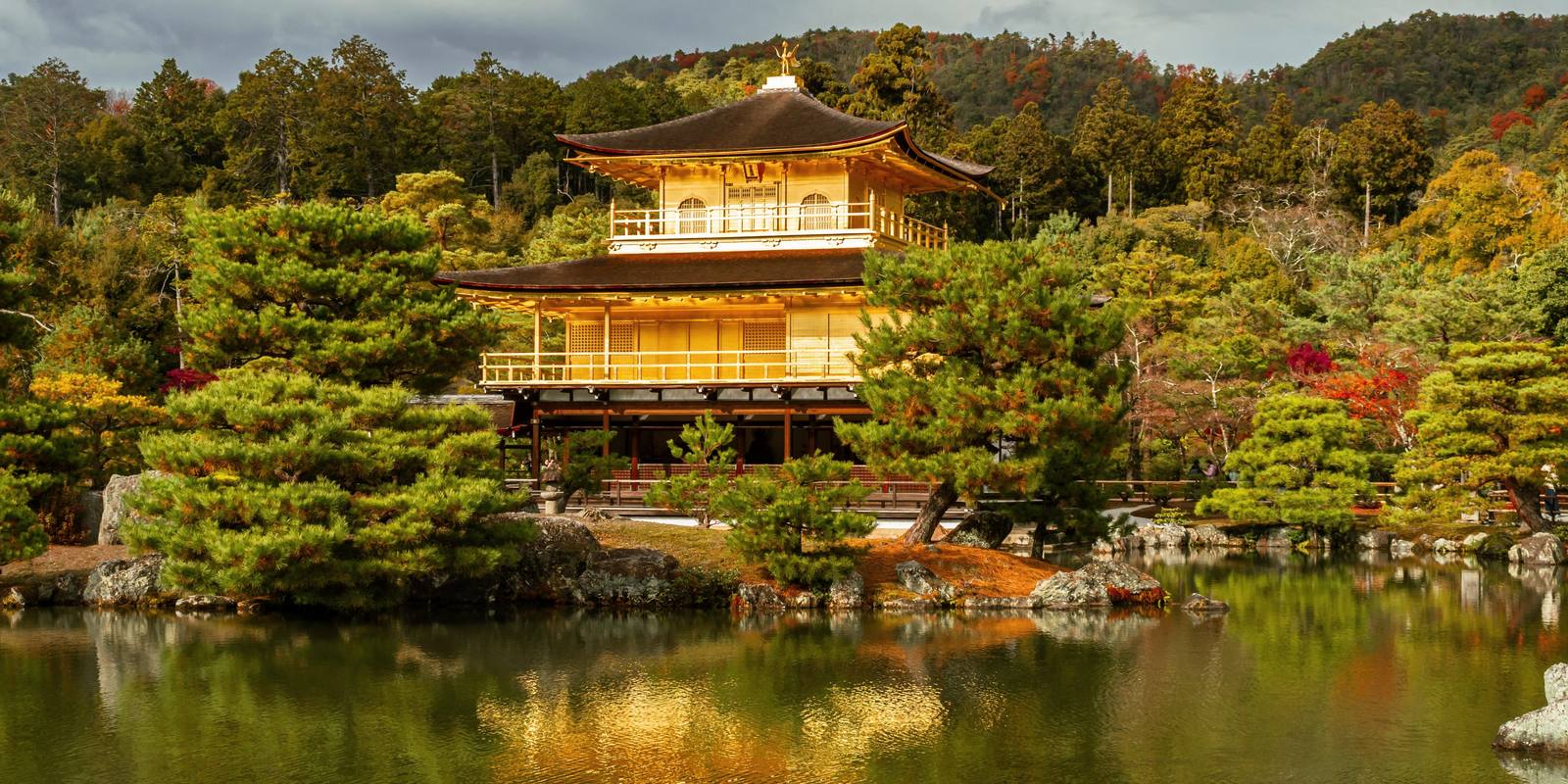 The Golden Pavilion (Kinkaku-ji) above its reflecting pond with autumn colour on the Kyoto hills behind